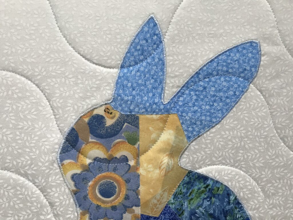 appliqued patchwork bunny on a baby quilt