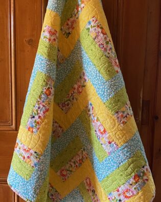 blue, green and yellow baby quilt