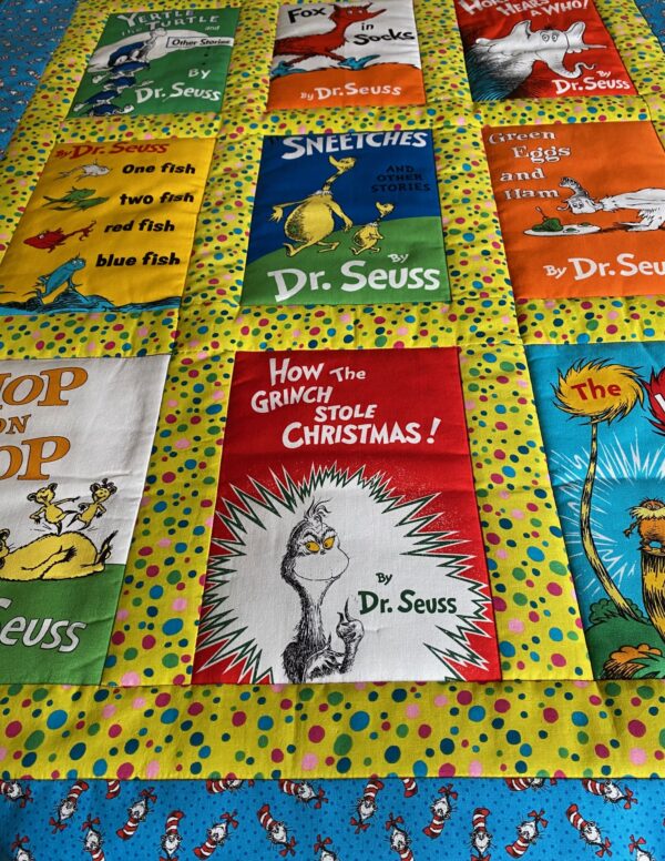 Dr. Seuss book covers on a quilt with book included