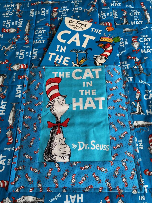 Dr. Seuss book covers on a quilt with book included