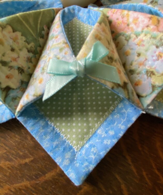 detailed view of a fabric hydrangea wreath showing attached pale blue bow