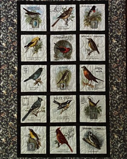 quilted wall hanging featuring 15 songbirds