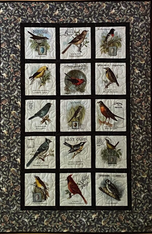 quilted wall hanging featuring 15 songbirds