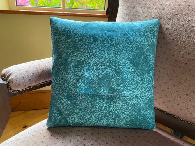 back side with envelope closure of a vintage-look patchwork cushion made with Laura Ashley fabric