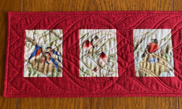 closer detailed look at the right half of the Birds of a Feather Table Runner in Red