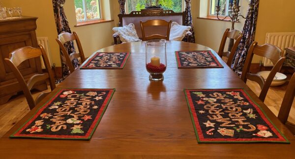 A dining room featuring Christmas placemats on the dining table