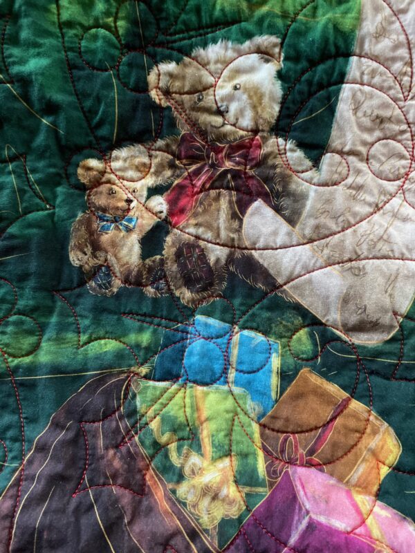 Detail of a Christmas throw quilt featuring Santa Claus checking his list