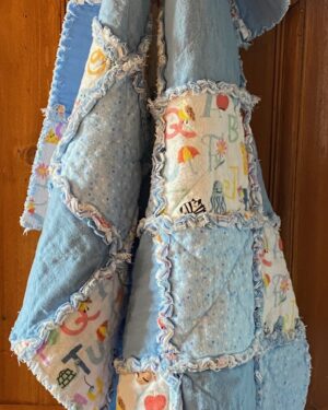 a small rag quilt in blue fabrics for a baby boy