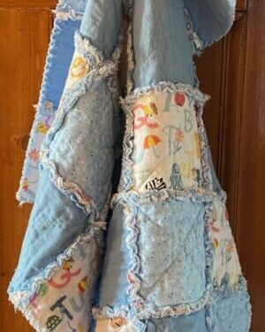 a small rag quilt in blue fabrics for a baby boy