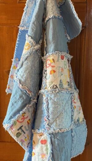 a small rag quilt in blue fabrics for a baby boy