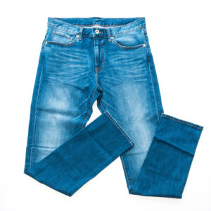 a pair of partially faded blue jeans with the legs bent up