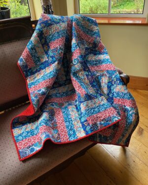 colourful throw quilt in a rail fence pattern