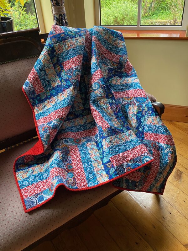 colourful throw quilt in a rail fence pattern