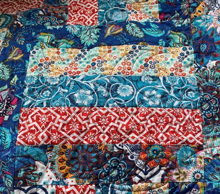 A close-up view of a colourful floral quilted throw