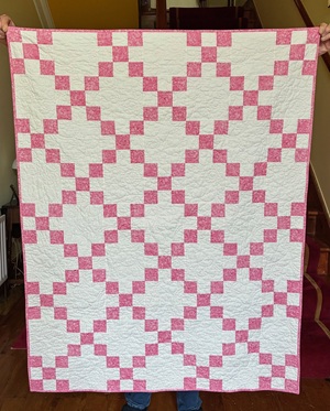 pink and white quilt for baby girl made with the Irish Chain pattern