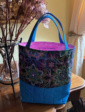 quilted tote bag with colourful dot designs resembling peacock feathers