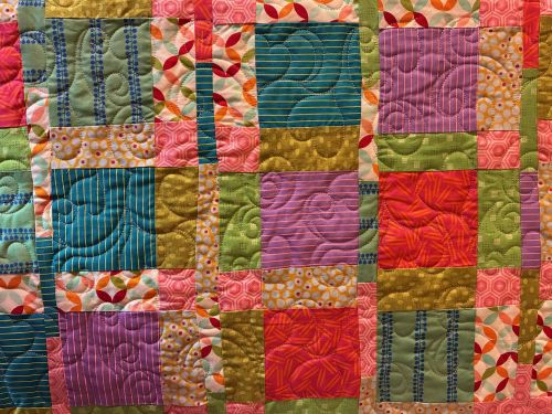 longarm quilting on a colourful baby quilt
