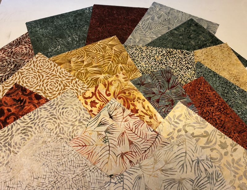 A layer cake group of autumn fabrics